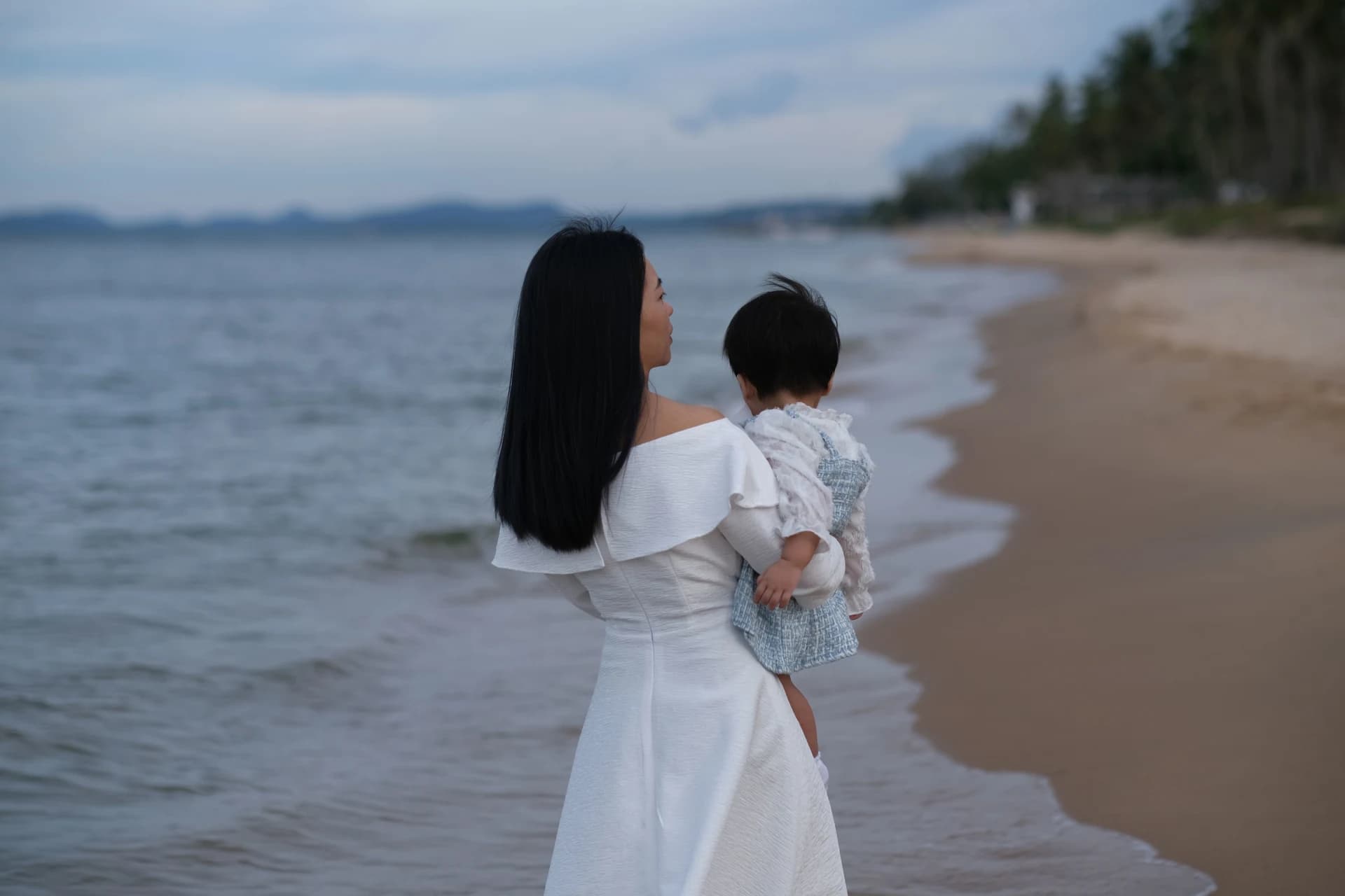 Mother and child walking on a beach in Phu Quoc, Vietnam