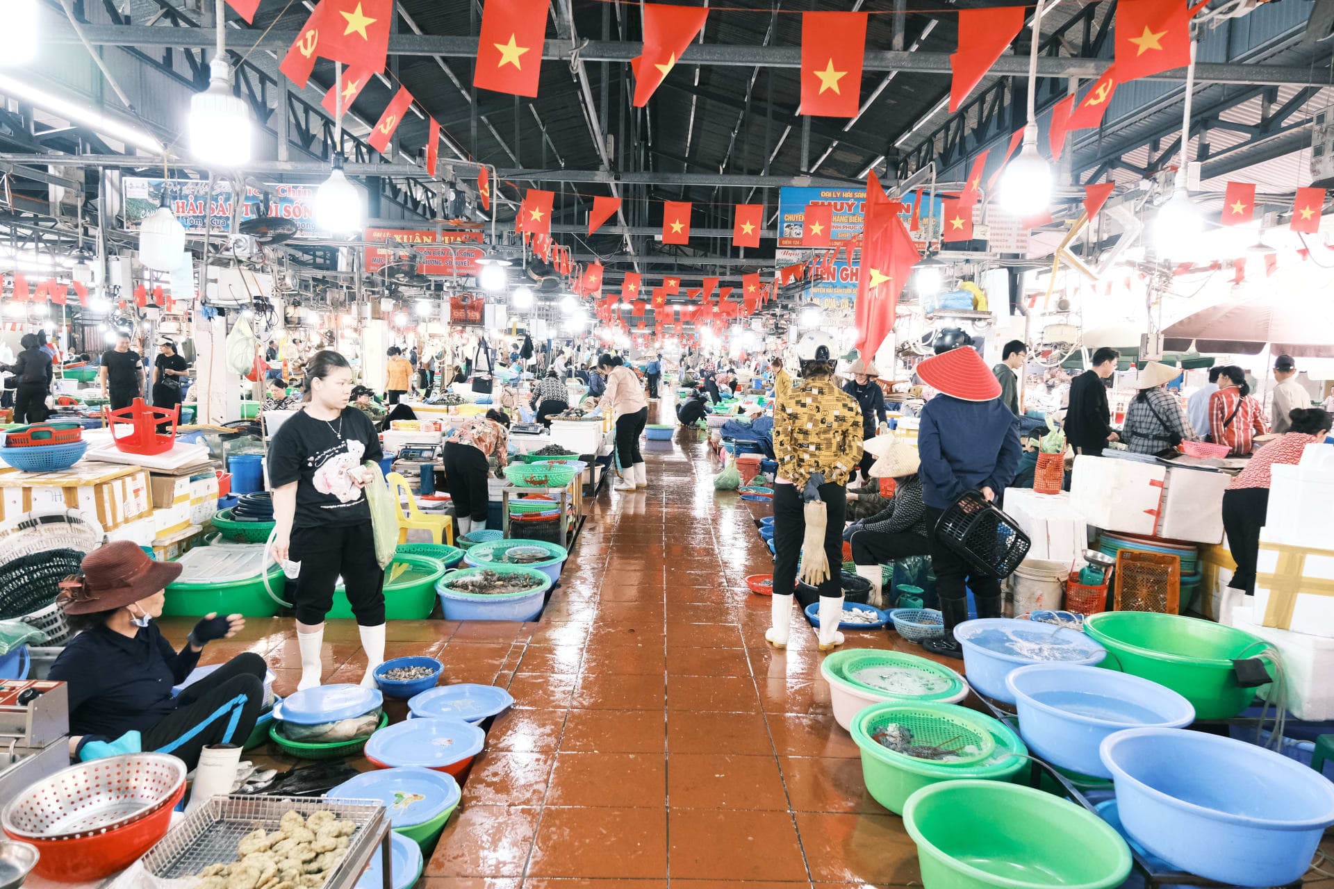 Busy Vietnamese fish market with seafood vendors