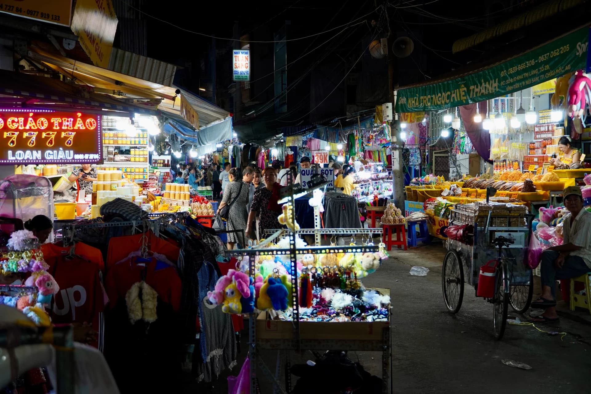 Night-market stalls and shoppers in Vietnam